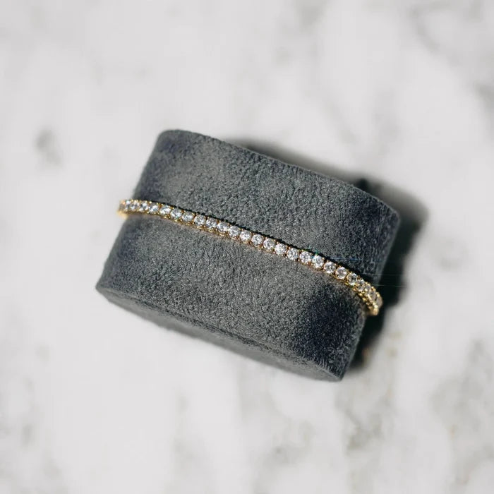 18K gold-plated zircon tennis bracelet by MANDOTOS featuring sparkling cubic zirconia stones on a delicate chain