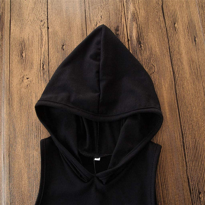 Black hooded sleeveless top on wooden background, stylish casual fashion