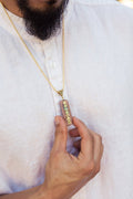 Seven chakra orgone copper pendant with chain, featuring colorful chakra stones and intricate design, on a black background.
