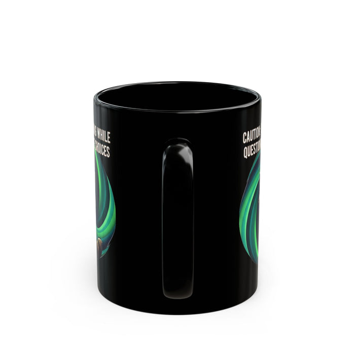 Black mug with green and white design on a white background