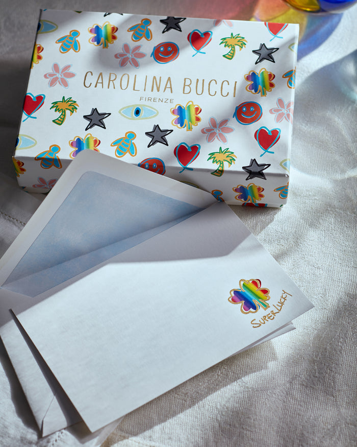 Pineider lucky stationary kit on white fabric background