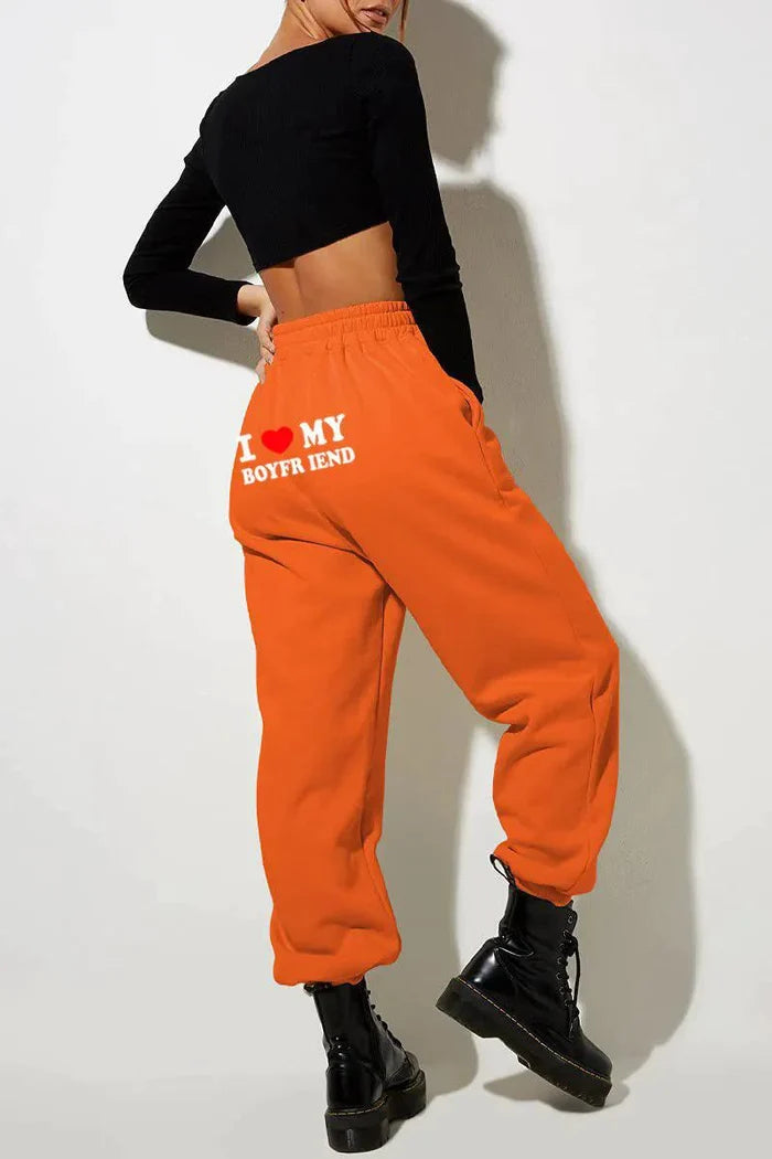 Mandotos chic love print trousers featuring a stylish pattern, tailored fit, and comfortable fabric for casual or semi-formal wear.