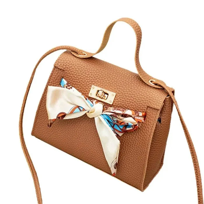 Elegant leather handbag and matching scarf from MANDOTOS, featuring stylish design and high-quality materials.