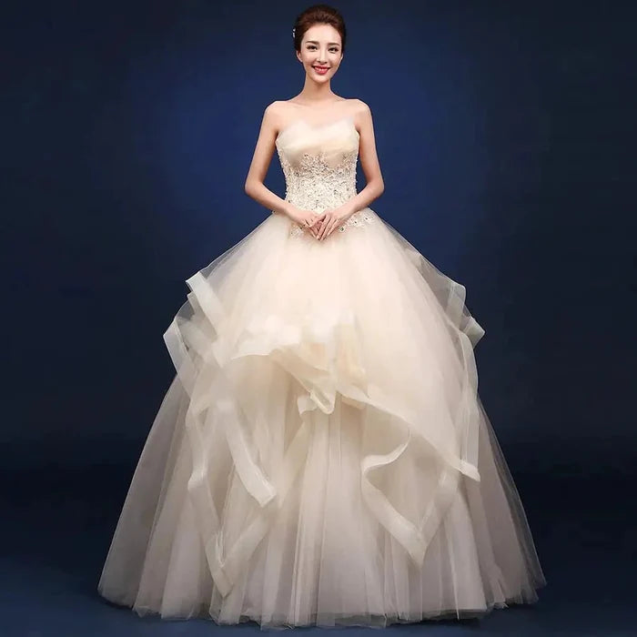Elegant one-shoulder bridal gown by MANDOTOS INTERNATIONAL featuring flowing fabric and intricate detailing for a sophisticated look.