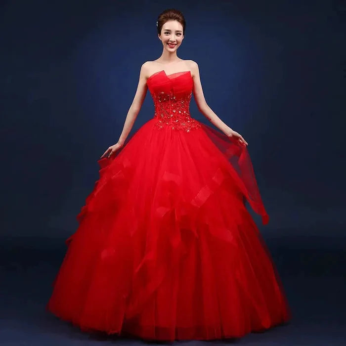 Elegant one-shoulder bridal gown by MANDOTOS INTERNATIONAL featuring flowing fabric and intricate detailing for a sophisticated wedding look.