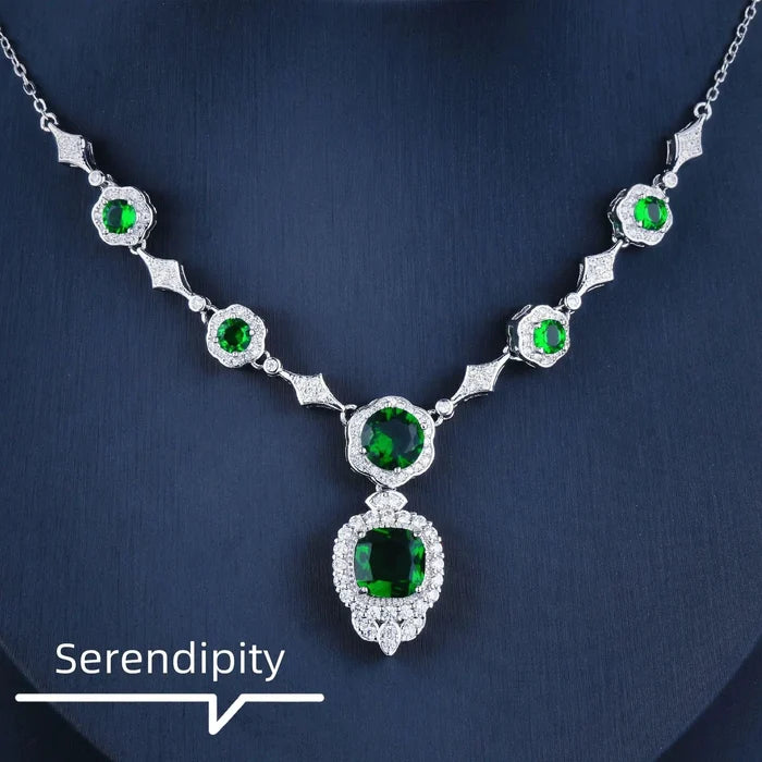 Mandotos Emerald Elegance white gold necklace featuring a central emerald gemstone and delicate chain for sophisticated style.