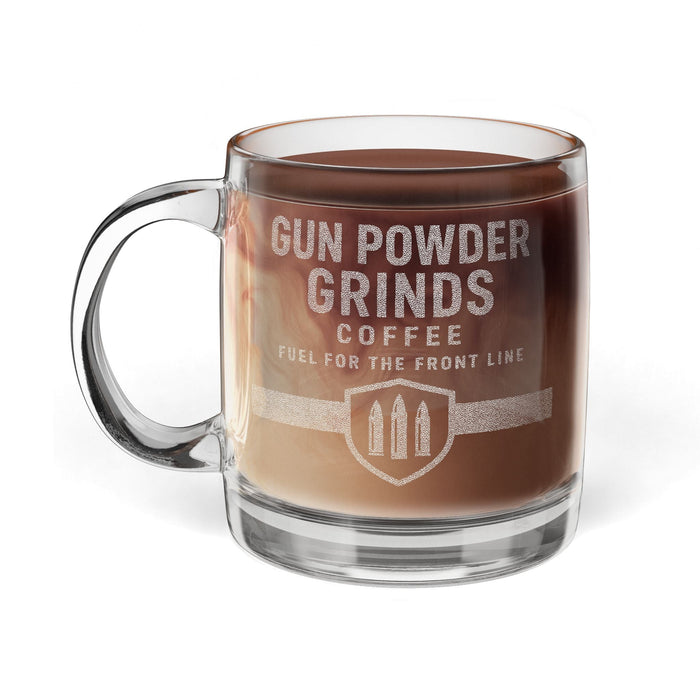 Glass mug with 'Gun Powder Grinds Coffee' text and design on a white background