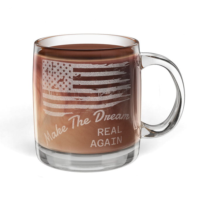 Clear glass mug with American flag design and text filled with hot chocolate on a white background