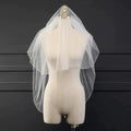 Ethereal double-tiered veil by MANDOTOS featuring delicate lace and airy tulle for a soft, romantic bridal look.