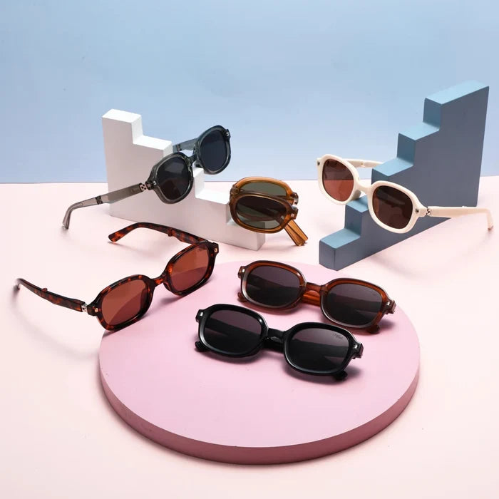 Black foldable retro oval sunglasses with UV400 polarized lenses and TR90 frame, unisex style by MANDOTOS INTERNATIONAL.