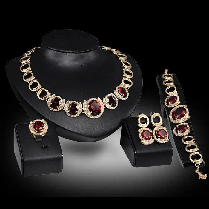 Mandotos gold jewelry set with four pieces featuring blue gemstones, perfect for wedding or special occasion accessories.