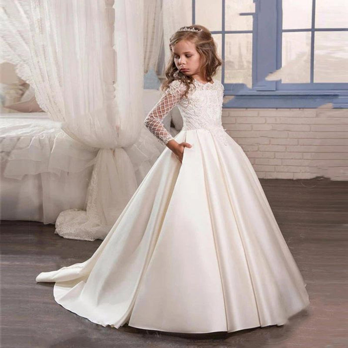 Little girl wearing a champagne-colored long sleeve dress by Ancient Energy, featuring soft fabric and elegant design.