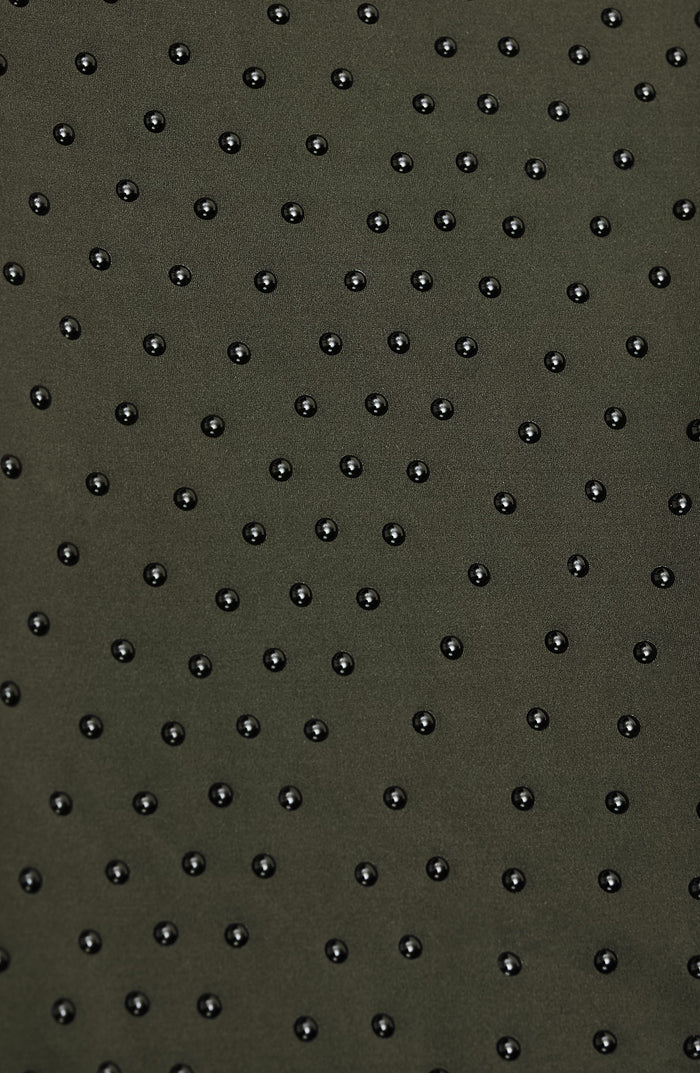 Olive green fabric with black stud detailing, ideal for fashion apparel and accessories