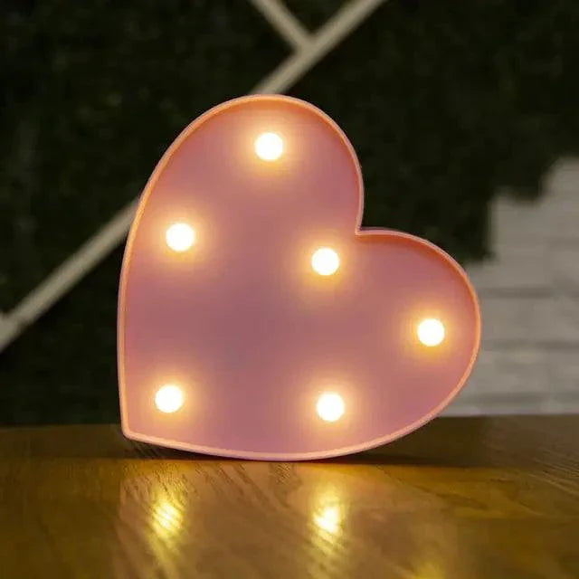 Mandotos luminous letter lights spelling out "LOVE" on a wall, decorative ambient lighting for home or party decor.