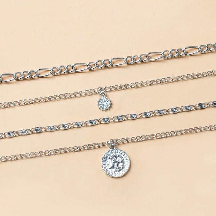 Mandotos chunky gold layered necklace featuring a coin pendant and sun charm for women, stylish jewelry accessory.