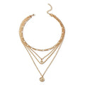 Mandotos chunky gold layered necklace with coin pendant and sun charm, designed for women, featuring bold, stylish jewelry.
