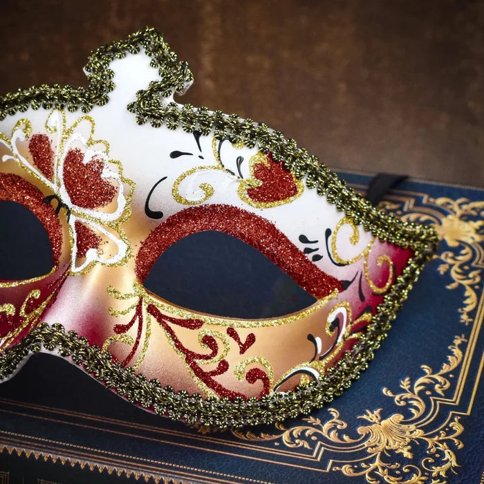 Men's glitter half face mask by MANDOTOS INTERNATIONAL, ideal for masquerade balls and Halloween costumes, featuring sparkling embellishments.