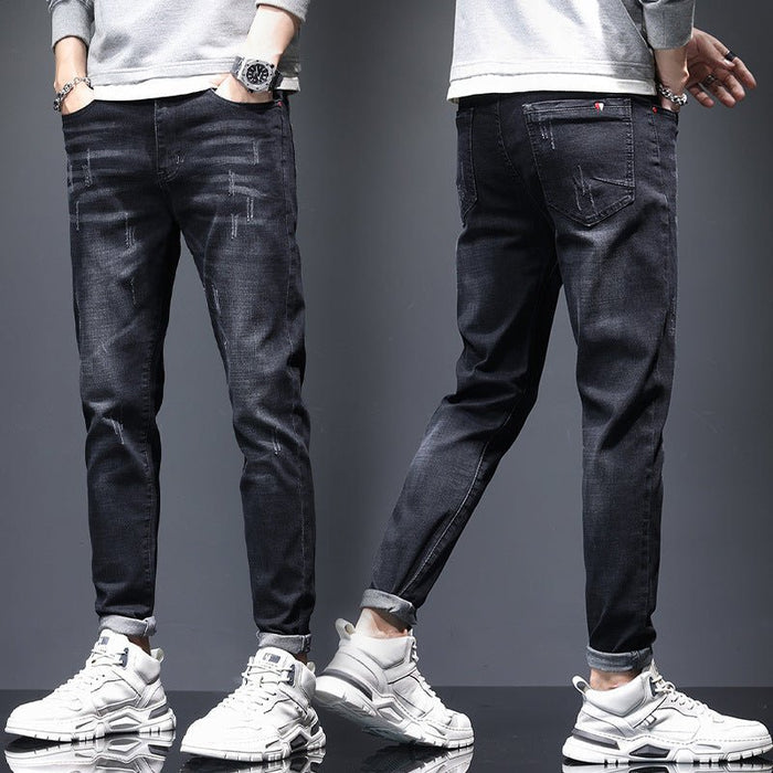 Mens ripped denim jeans with cat-whisker scratches from Ancient Energy, showing distressed fabric and stylish design details.