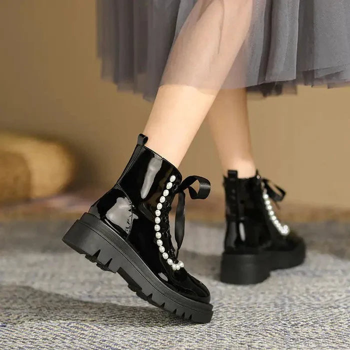 Mandotos patent leather ankle boots with sleek design, rounded toe, and low heel, perfect for stylish everyday wear.