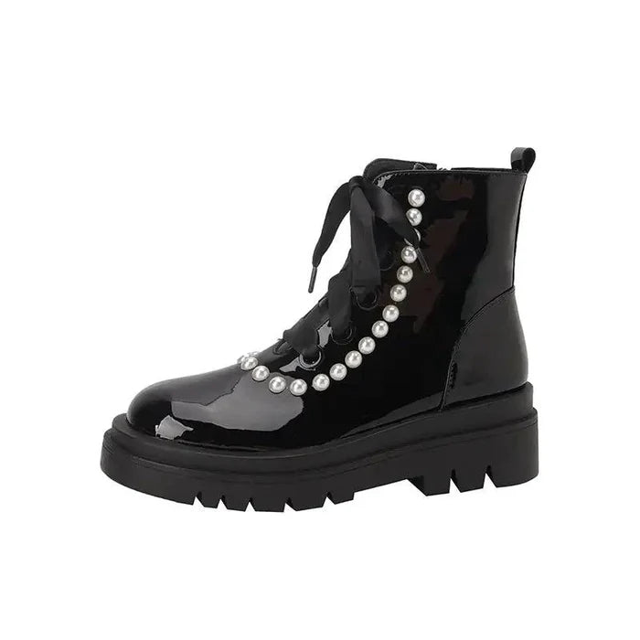 Black patent leather ankle boots by MANDOTOS with pointed toes and sleek design, perfect for stylish everyday wear.