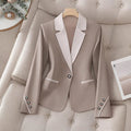 Elegant formal blazer by Ancient Energy featuring contrasting color buttons and a tailored fit for professional or dressy occasions.