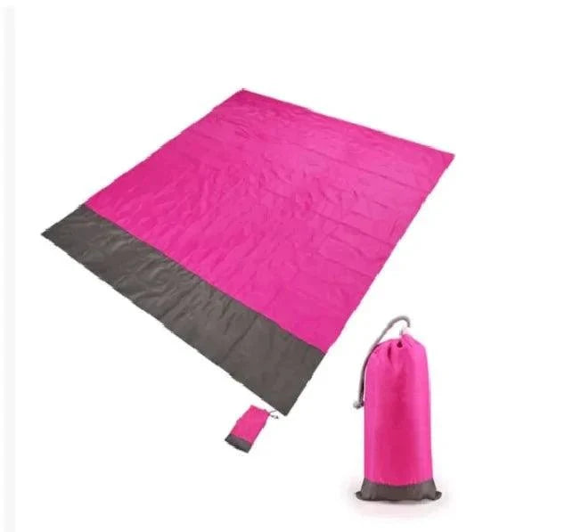 Mandotos sandproof portable beach mat laid out on sand, showing its lightweight design and easy foldability for beach trips.