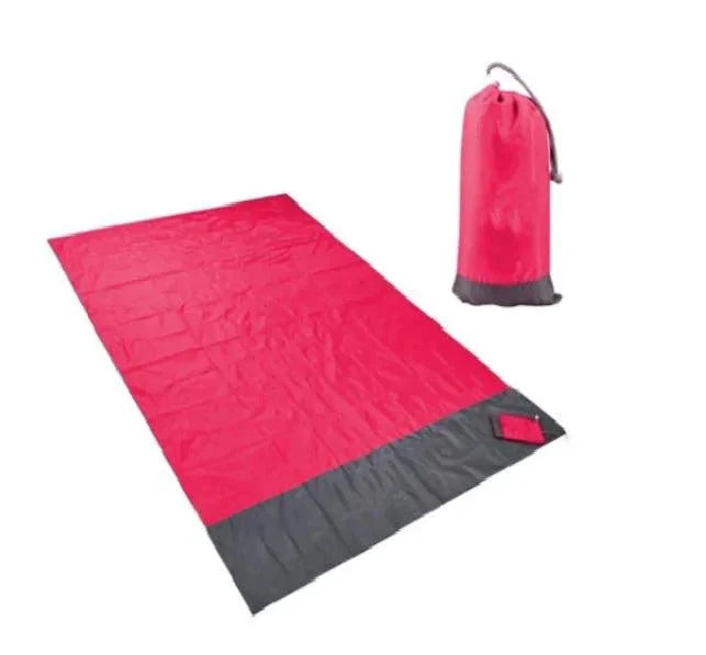 Mandotos sandproof portable beach mat spread out on sandy shore, lightweight and foldable for easy beach outings.
