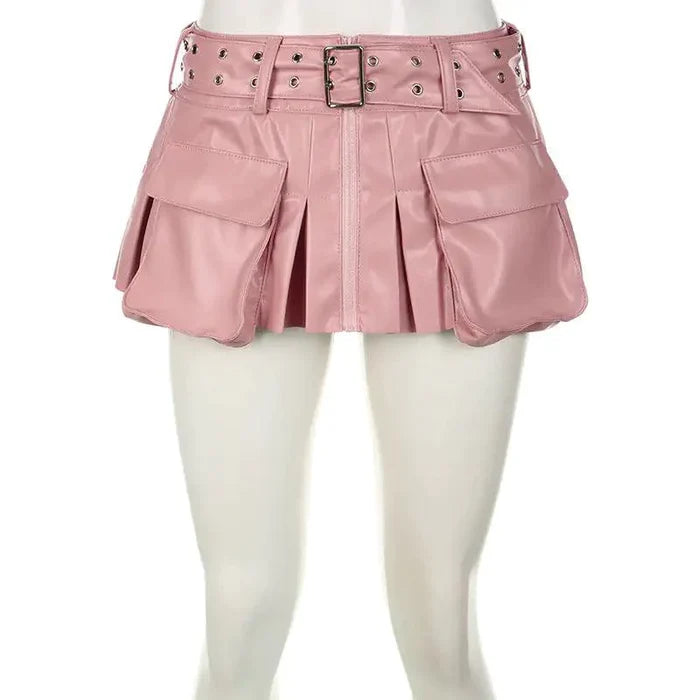 Mandotos Spice faux leather pleated mini skirt hanging on a hanger, showcasing its textured fabric and stylish design.