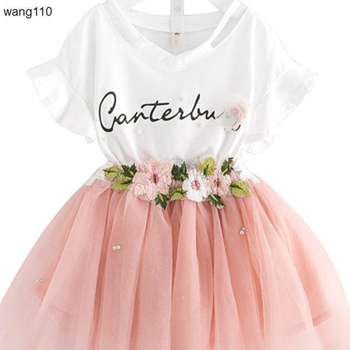 Girls' white V-neck dress with pink tulle skirt, floral embroidery, and 'Canterbury' script