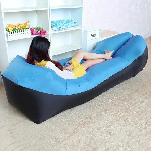 Mandotos SunScape Inflatable Lounger in vibrant orange with a built-in pillow, perfect for outdoor relaxation.