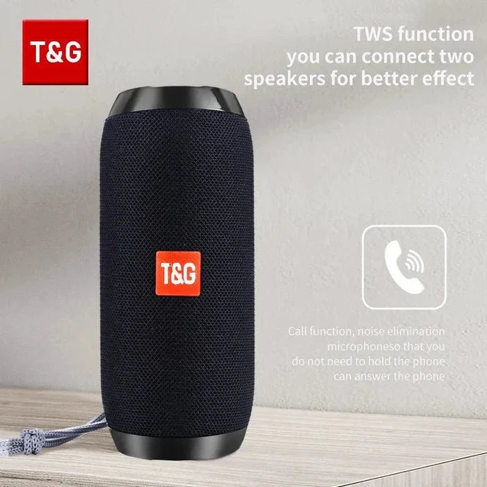 Mandotos TG117 Bluetooth portable waterproof TWS outdoor speaker placed on a surface with a nature background.
