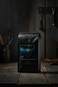 Gun Powder Grinds Night Walkers Whole Bean on wooden surface