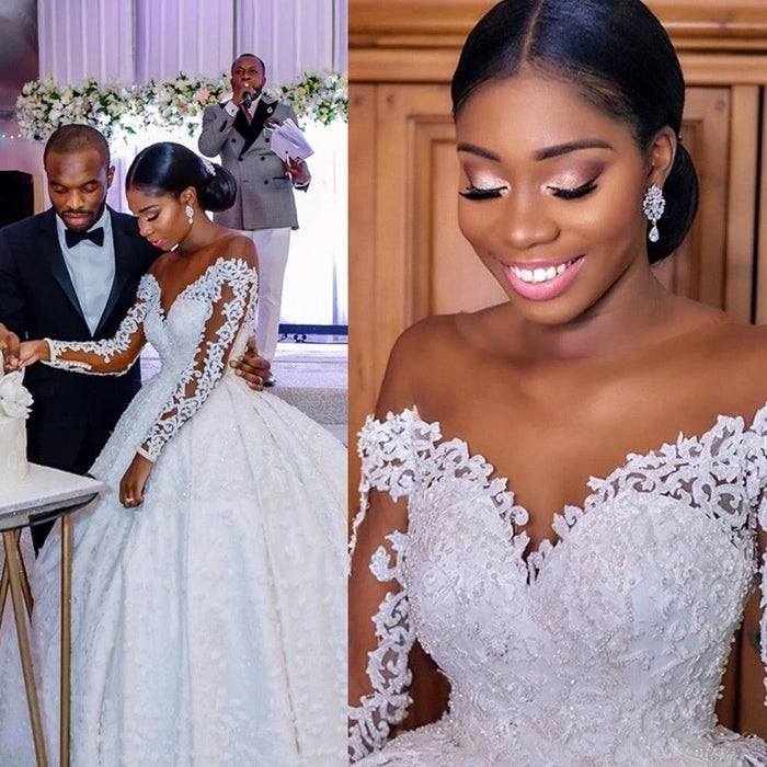Elegant custom wedding gown by Ancient Energy featuring intricate lace details and a flowing train for bridal elegance.