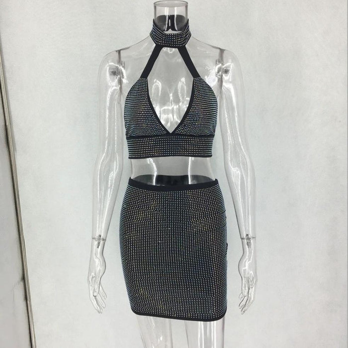 Women’s two-piece dress set with diamond embellishments by MANDOTOS, featuring a stylish top and matching skirt.